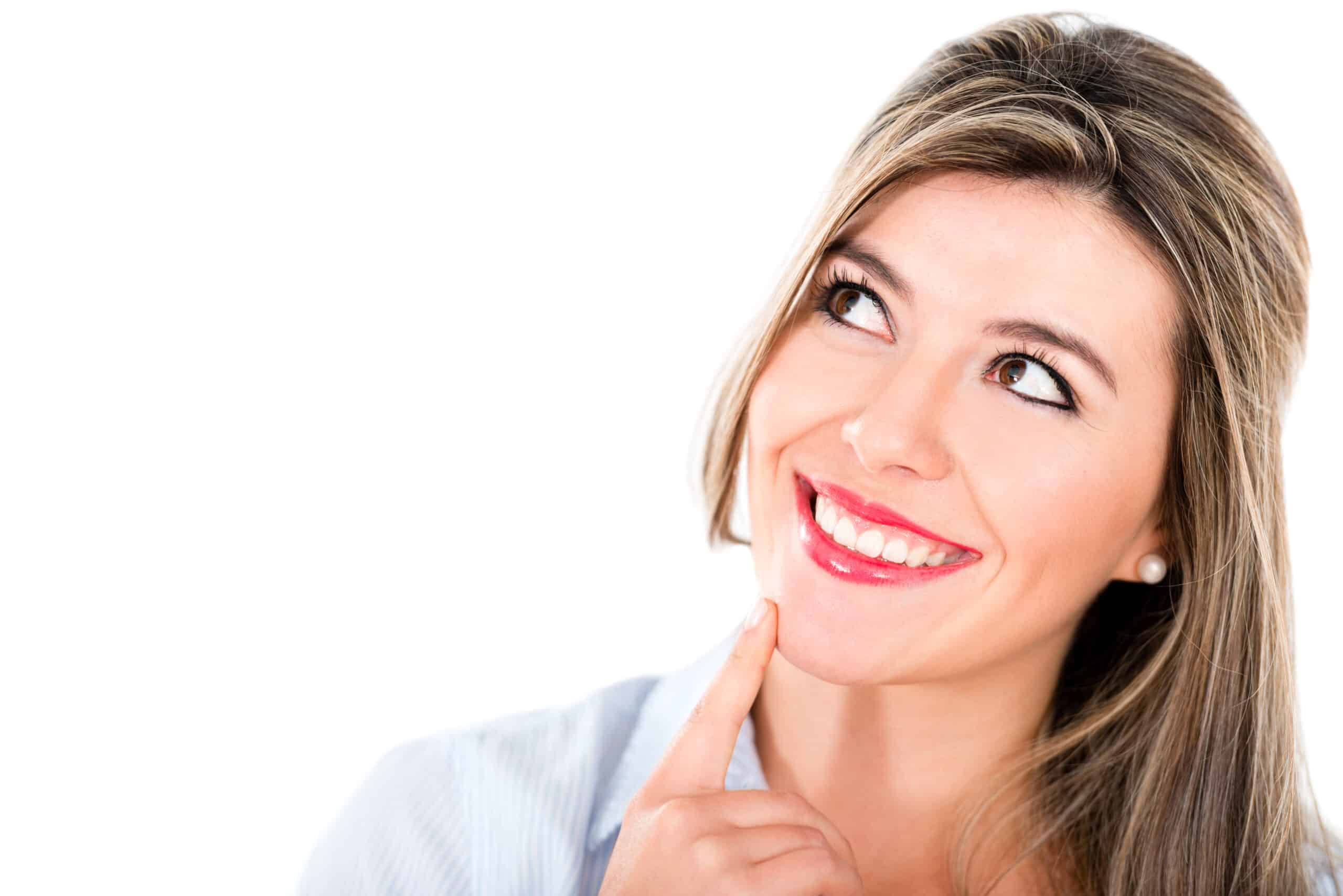 Woman smiling confidently while thinking about cosmetic dentistry smile improvement.