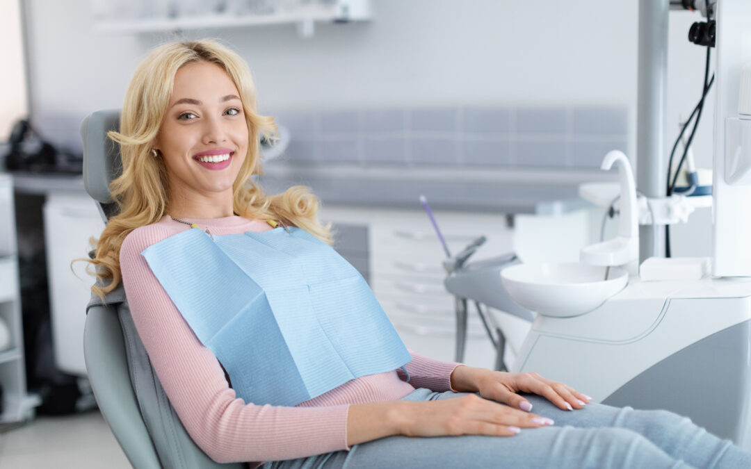 Adult patient smiling comfortably in a dental chair during a cosmetic dentistry visit, reflecting confidence and relaxed care