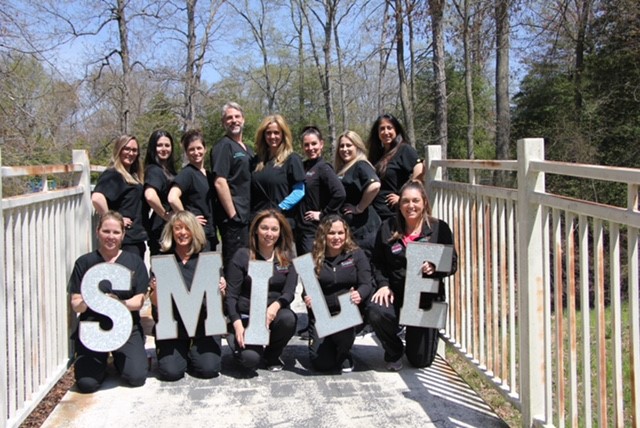 The full team of Adult & Pediatric Dental Studio gathered outdoors