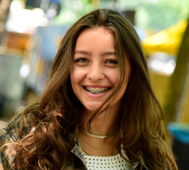 Smiling patient explaining why she chose Adult & Pediatric Dental Studio