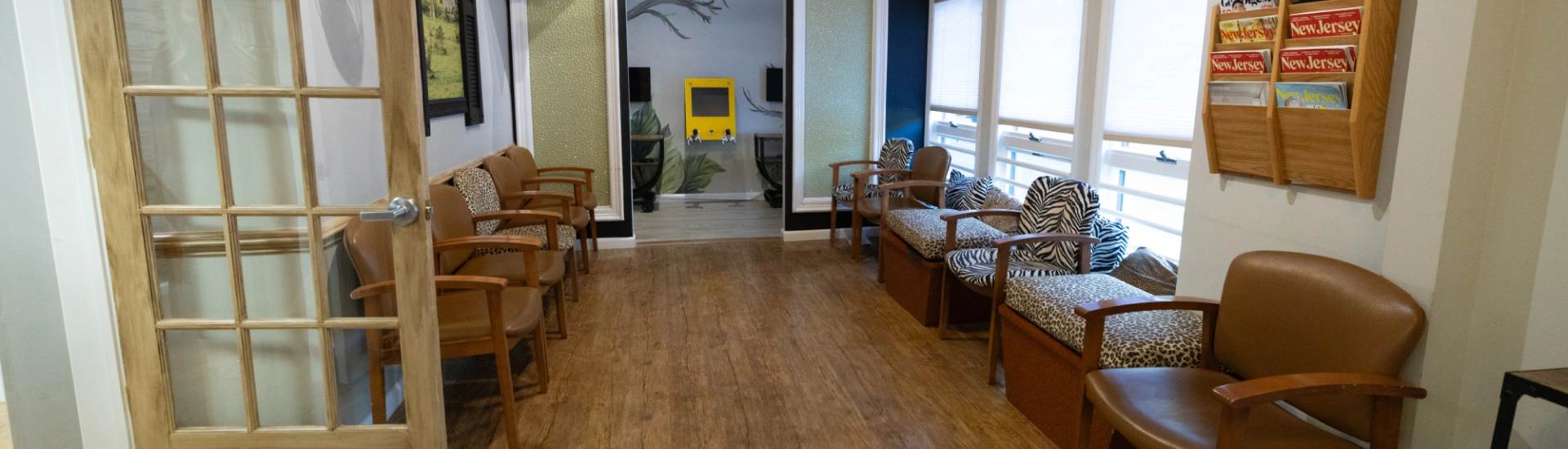 The reception waiting area of Adult & Pediatric Dental Studio with wood-look flooring