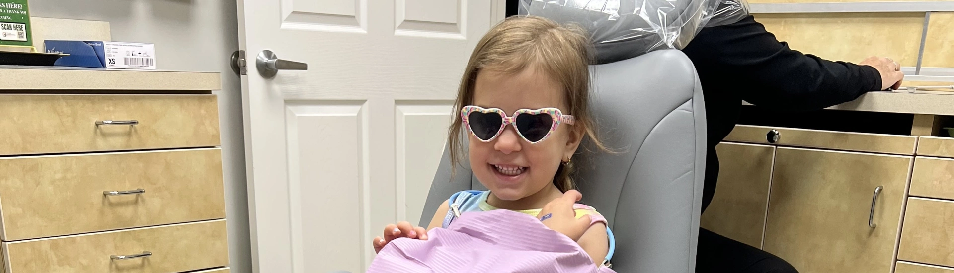 A cheerful young child patient during a dental visit at Adult & Pediatric Dental Studio