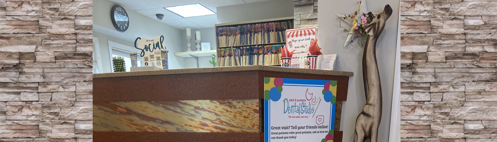 A wide view of the clean, organized front reception counter at the dental studio
