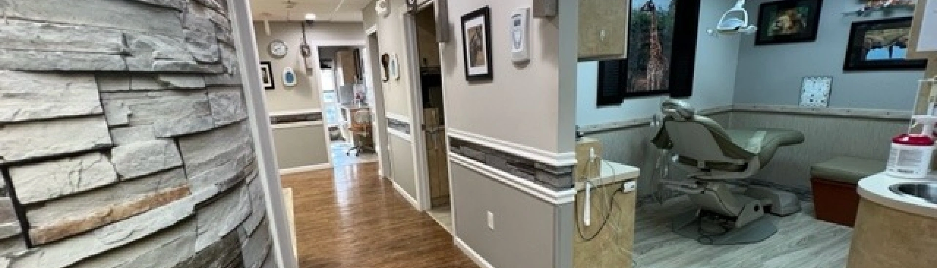 An interior view of Adult & Pediatric Dental Studio showing an exam room and office hallway