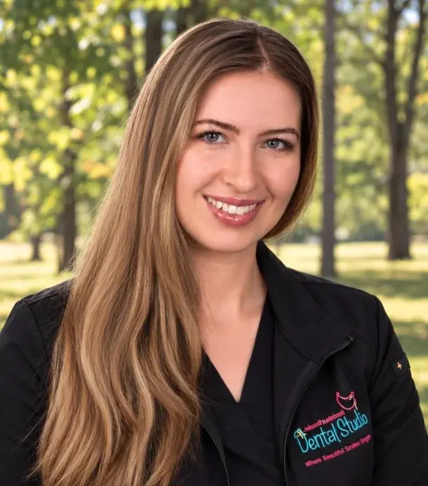 Dr. Emily Schupp, dentist at Manalapan Dental Studio, smiling outdoors.