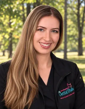 Dr. Emily Schupp, dentist at Manalapan dental practice, smiling outdoors.